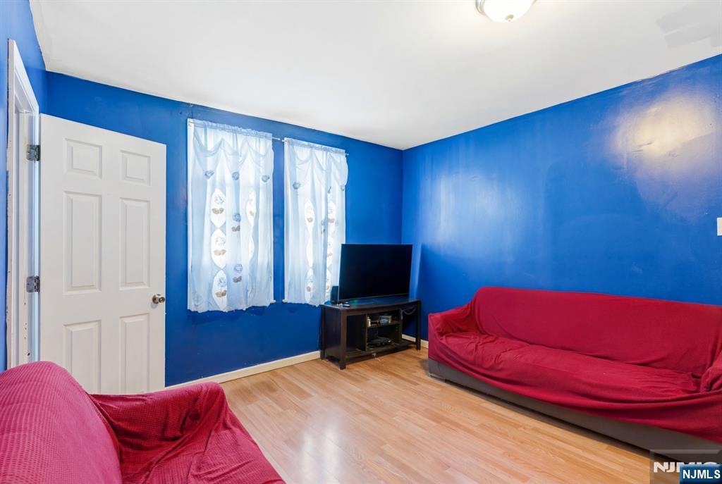 29 6th Avenue Newark, NJ 07104 - Photo 5 of 21 a bedroom with a bed and a flat screen tv
