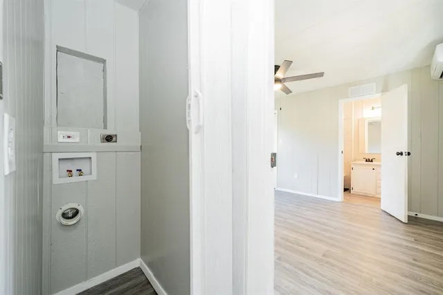 a view of a hallway with wooden floor