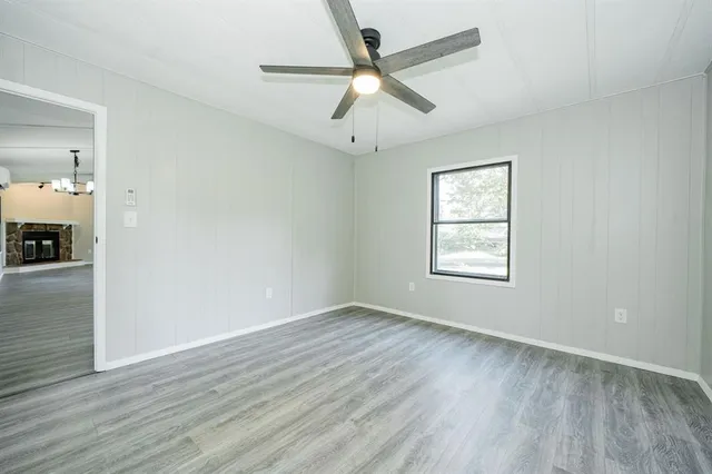 wooden floor in an empty room with a window