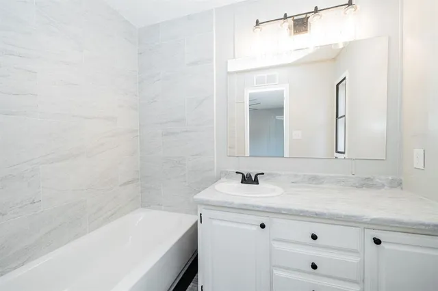 a bathroom with a sink and a bathtub