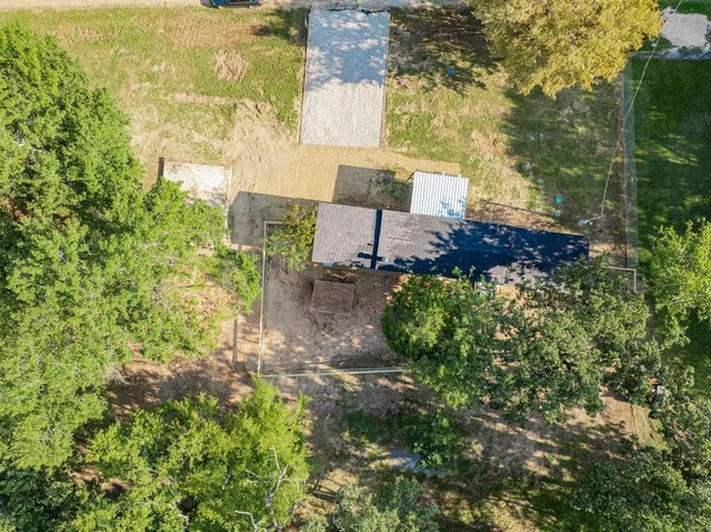 an aerial view of a house with a yard