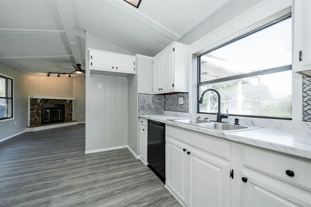 a kitchen with a sink appliances and cabinets