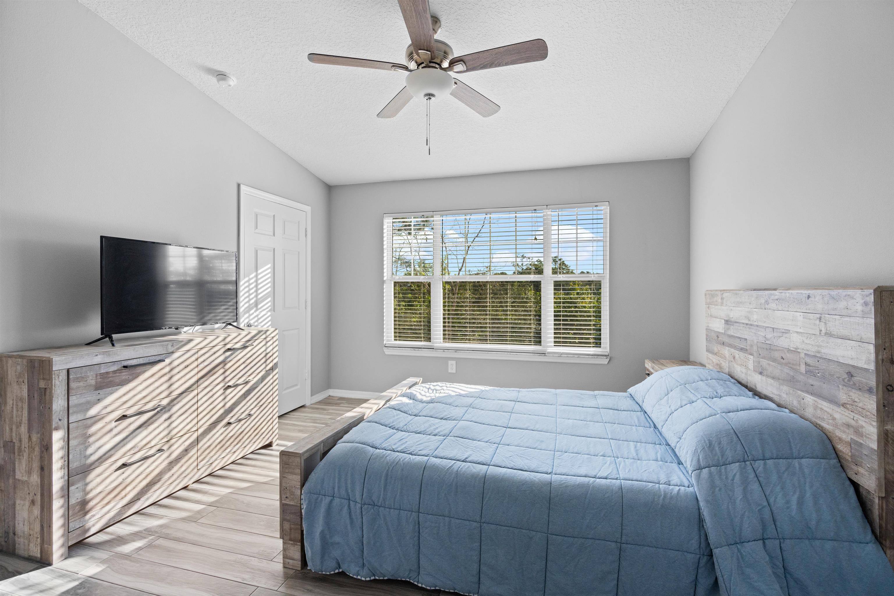 11207 Harbour Vista Circle, Unit 11207 St. Augustine, FL 32080 - Photo 11 of 42 a bedroom with a bed and a flat screen tv