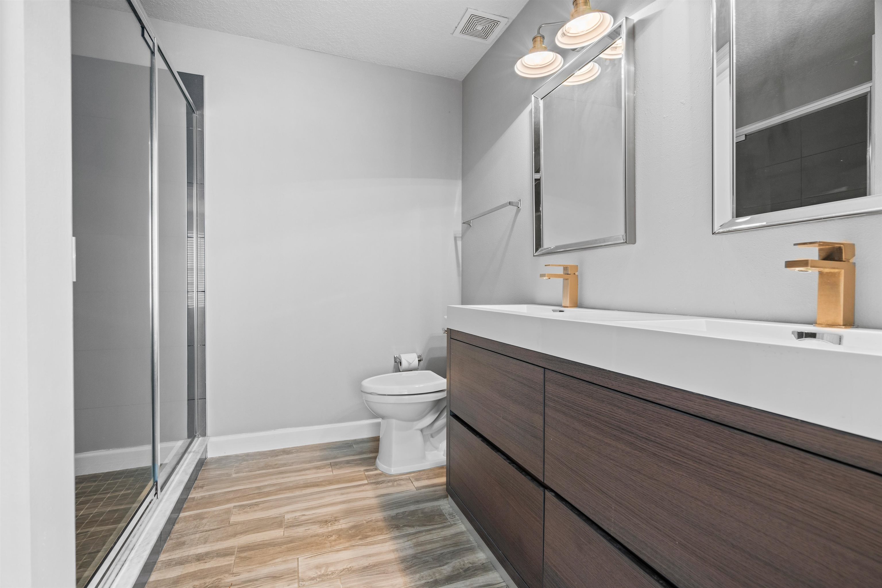 11207 Harbour Vista Circle, Unit 11207 St. Augustine, FL 32080 - Photo 12 of 42 a bathroom with a sink a toilet a mirror and shower