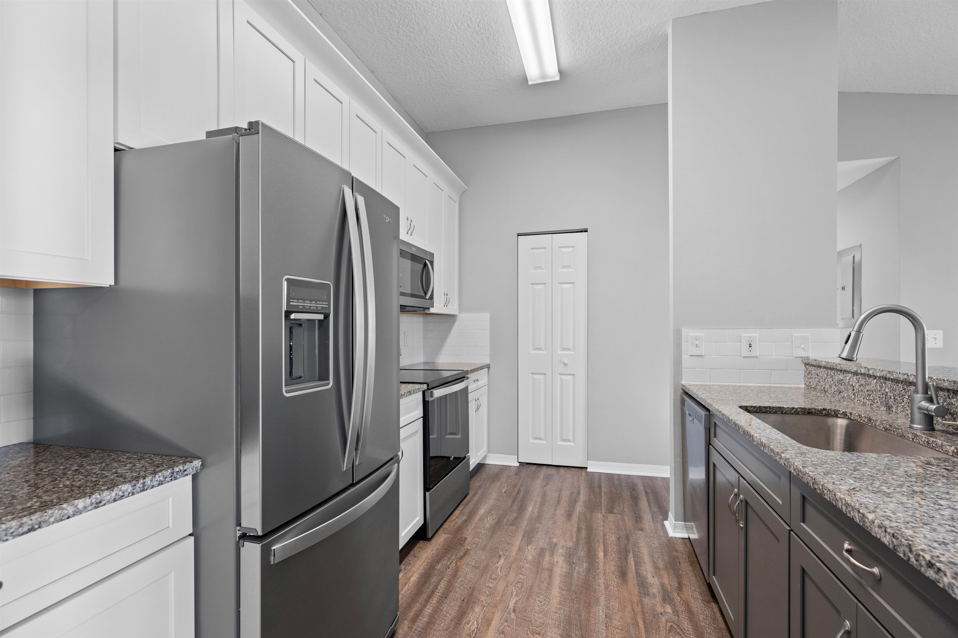 11207 Harbour Vista Circle, Unit 11207 St. Augustine, FL 32080 - Photo 13 of 42 a kitchen with stainless steel appliances granite countertop a refrigerator and a sink