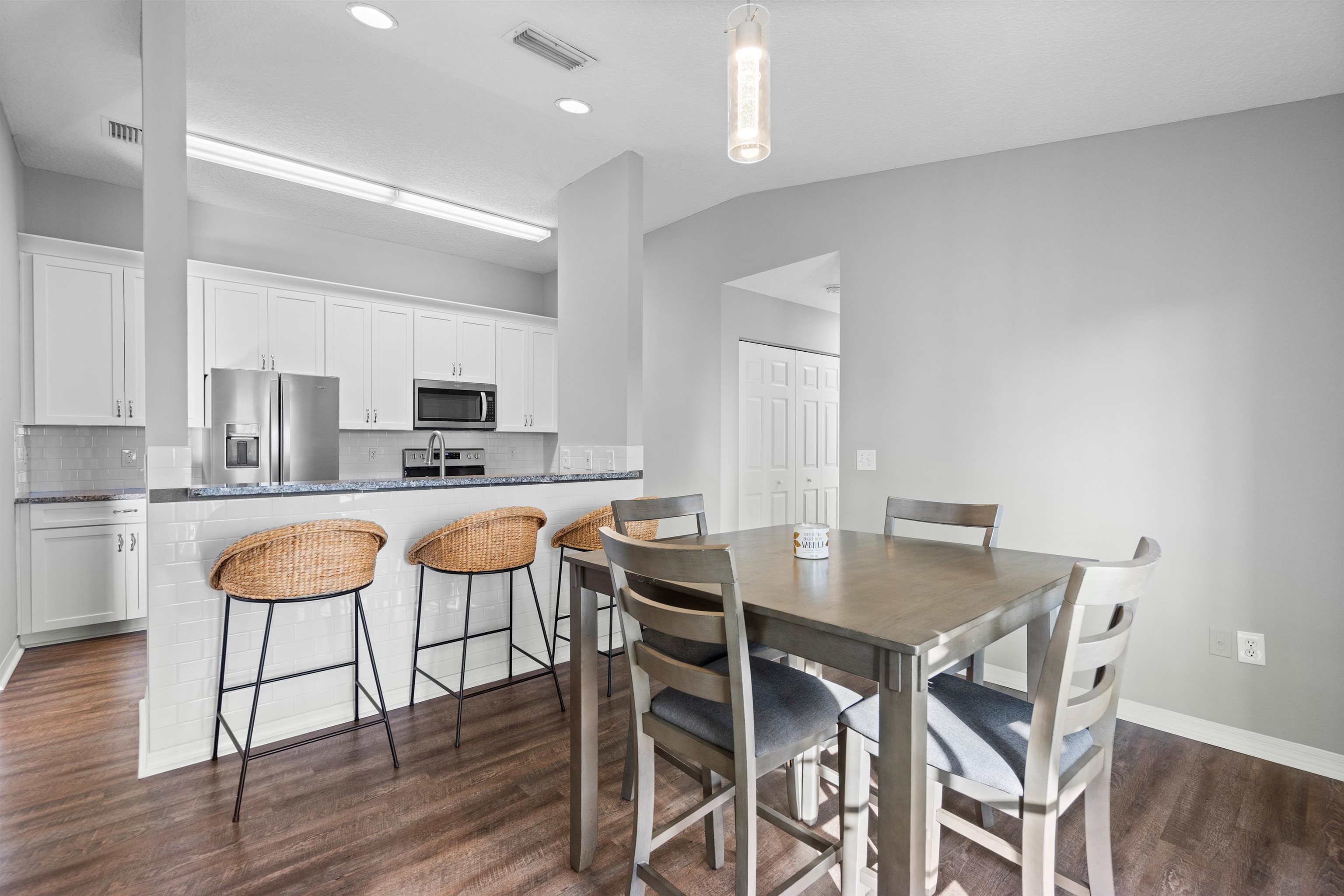 11207 Harbour Vista Circle, Unit 11207 St. Augustine, FL 32080 - Photo 17 of 42 a view of a dining room with furniture and wooden floor