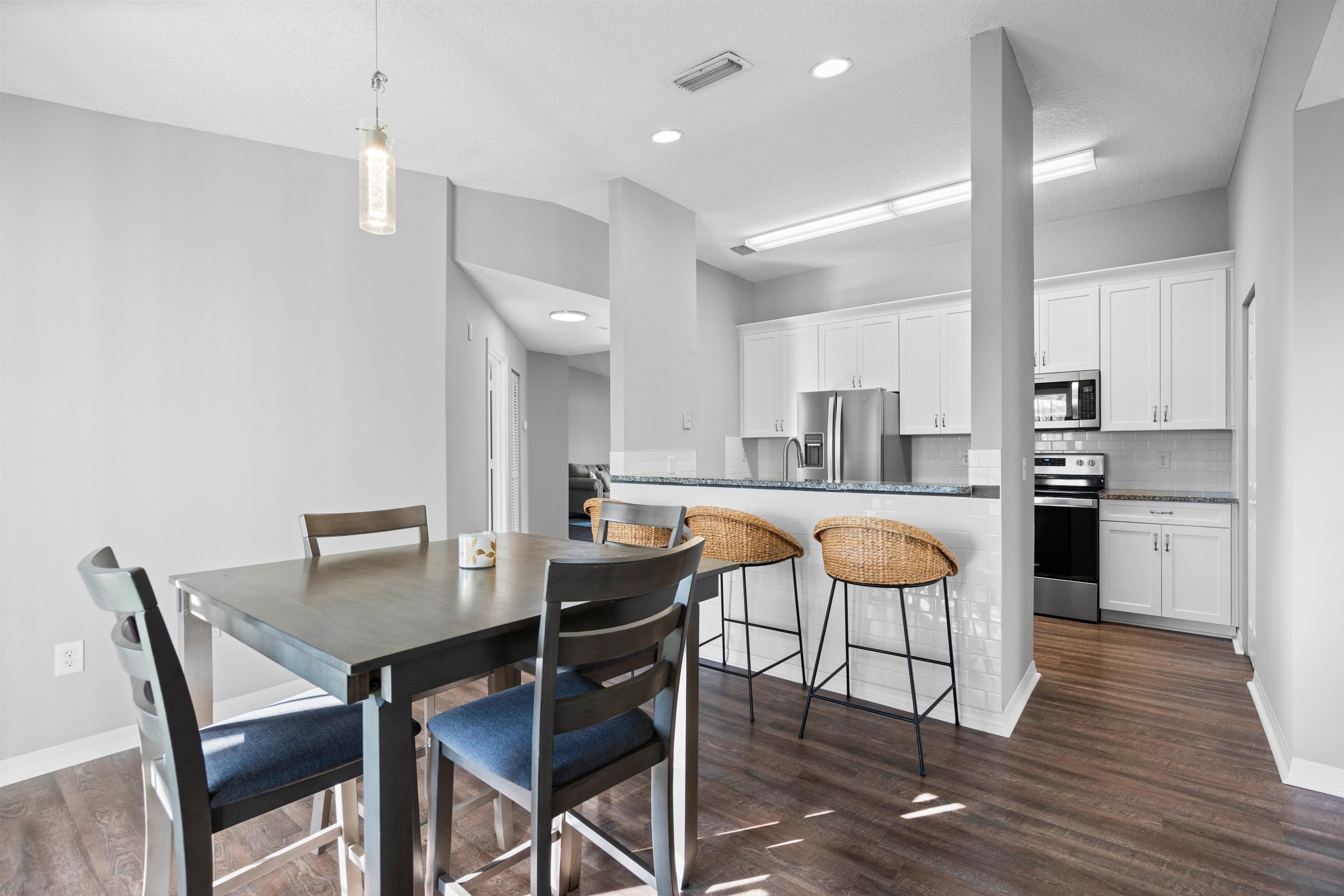 11207 Harbour Vista Circle, Unit 11207 St. Augustine, FL 32080 - Photo 18 of 42 a view of a dining room with furniture and wooden floor