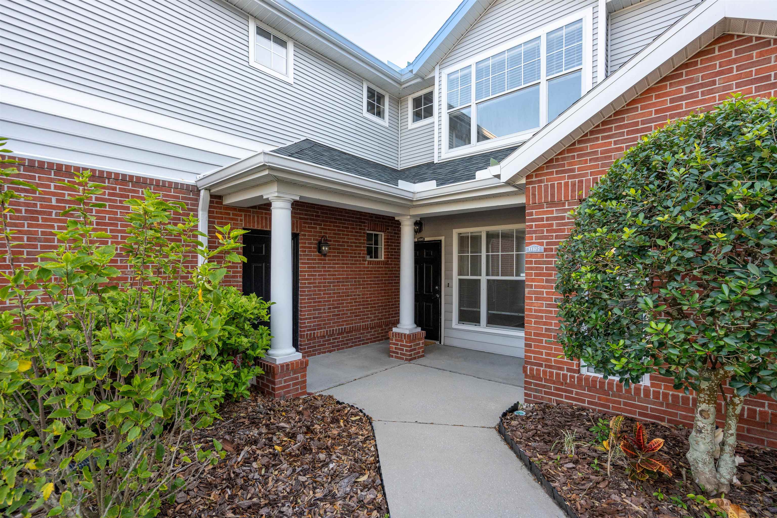 11207 Harbour Vista Circle, Unit 11207 St. Augustine, FL 32080 - Photo 2 of 42 a view of a porch with plants and bench