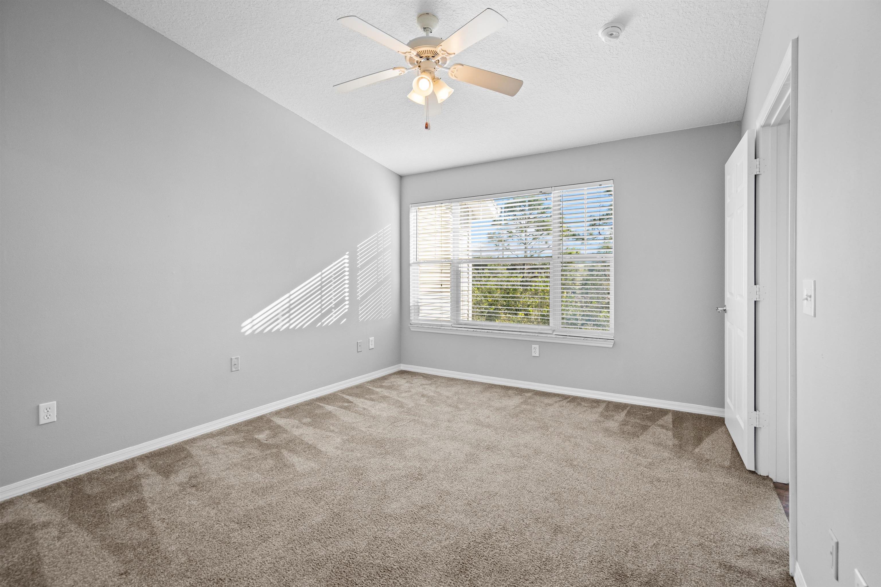 11207 Harbour Vista Circle, Unit 11207 St. Augustine, FL 32080 - Photo 25 of 42 an empty room with a window and a ceiling fan