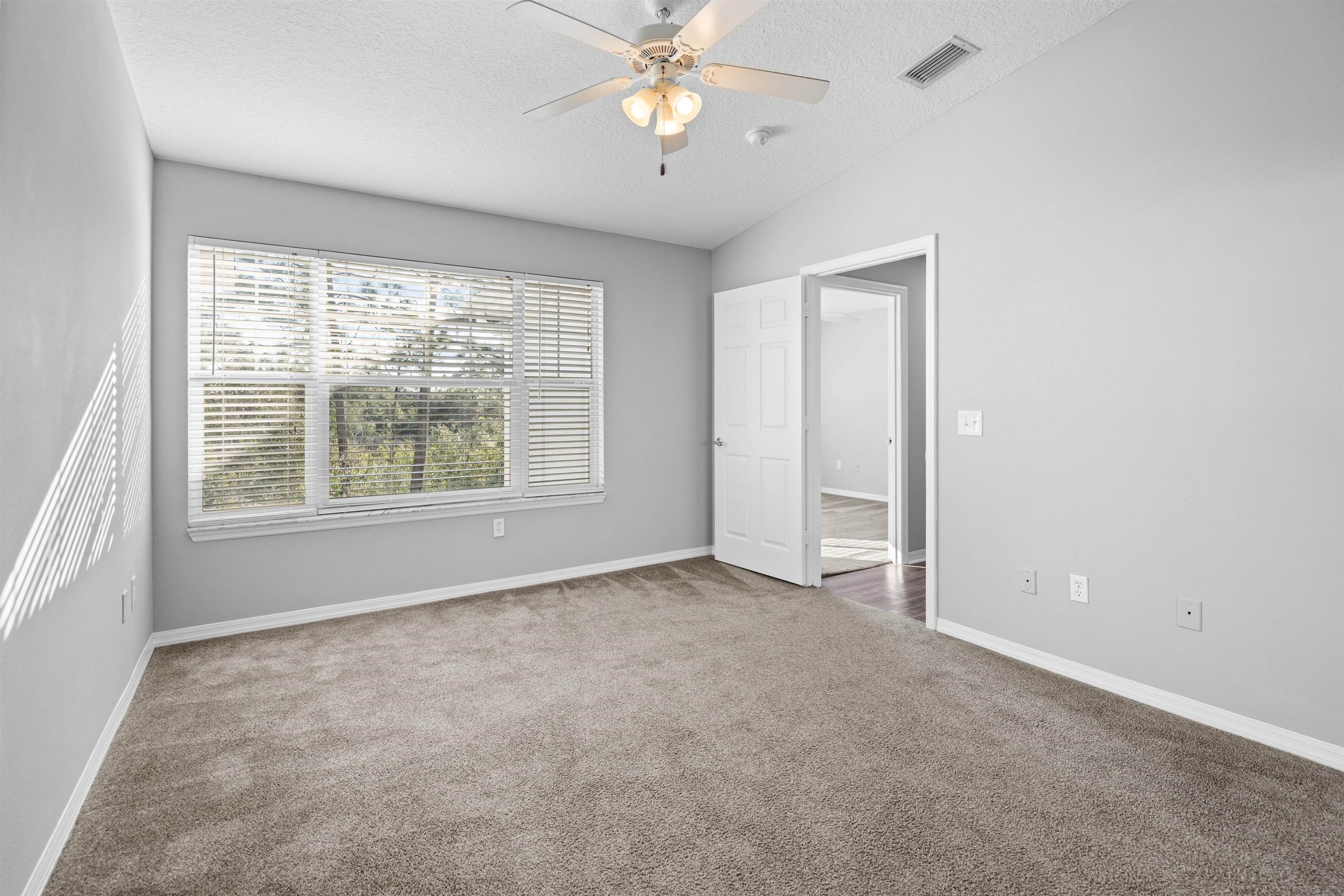 11207 Harbour Vista Circle, Unit 11207 St. Augustine, FL 32080 - Photo 26 of 42 an empty room with a window and a fan