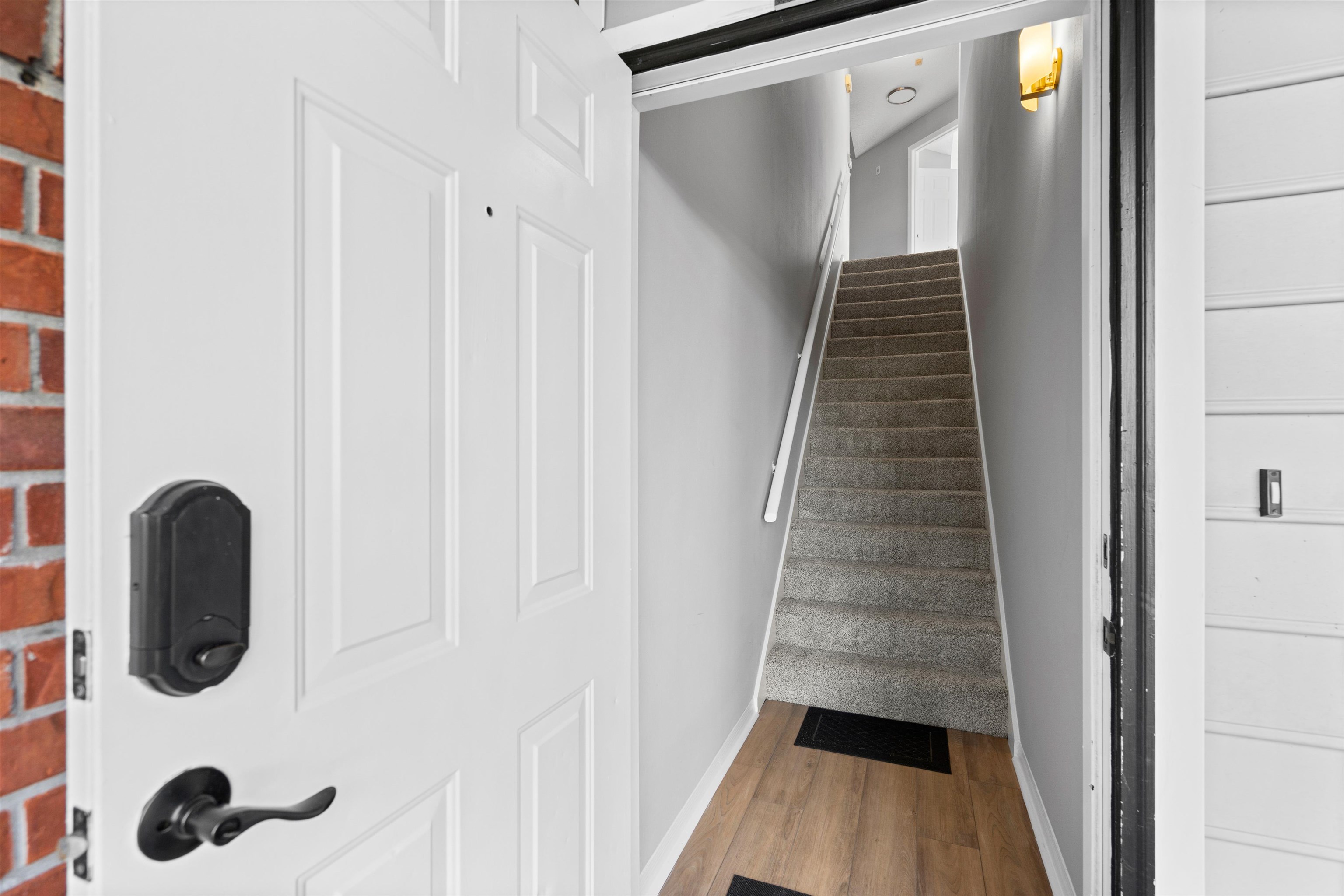 11207 Harbour Vista Circle, Unit 11207 St. Augustine, FL 32080 - Photo 3 of 42 a view of a hallway with wooden floor and staircase