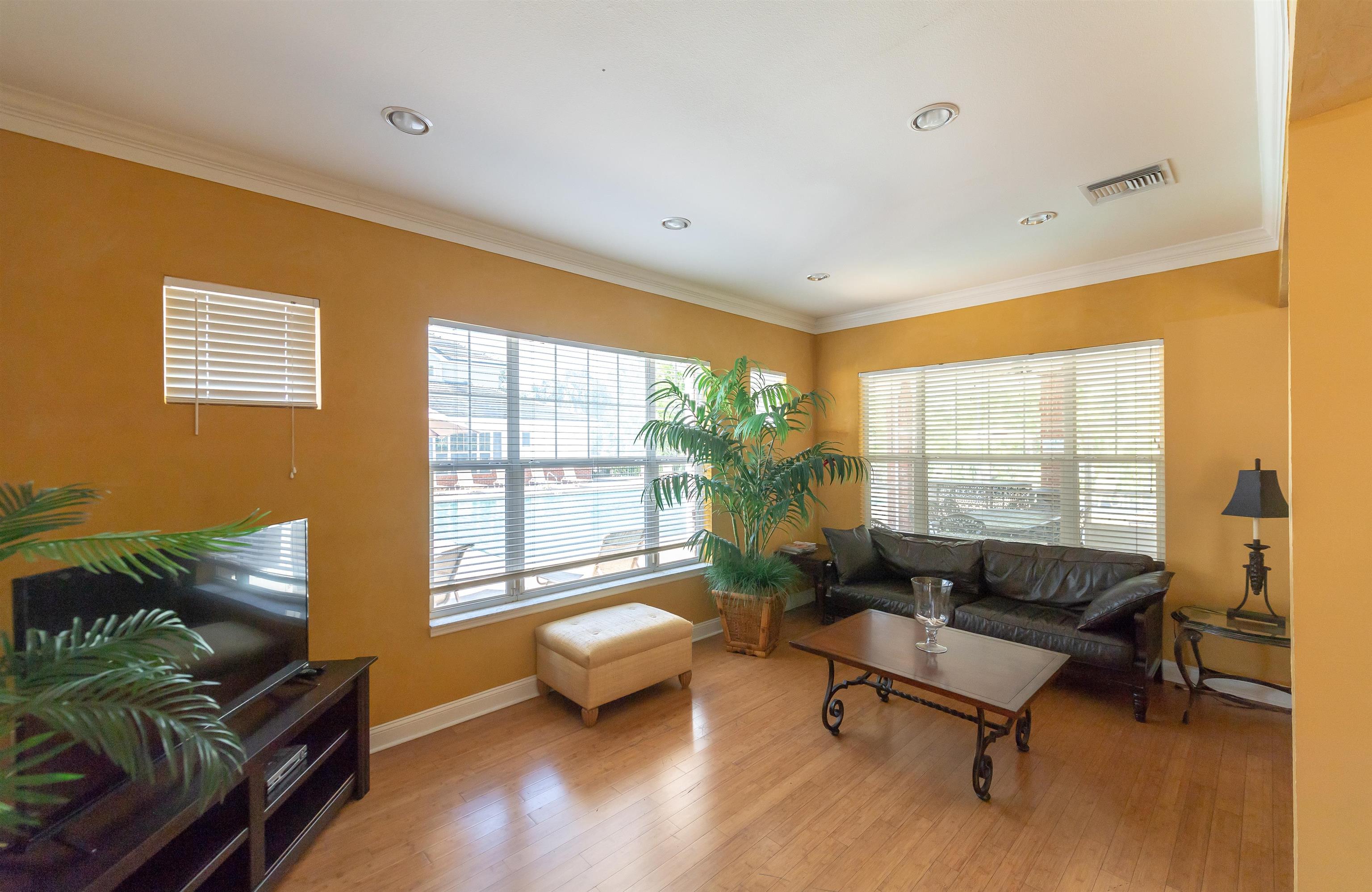 11207 Harbour Vista Circle, Unit 11207 St. Augustine, FL 32080 - Photo 31 of 42 a living room with furniture and a large window