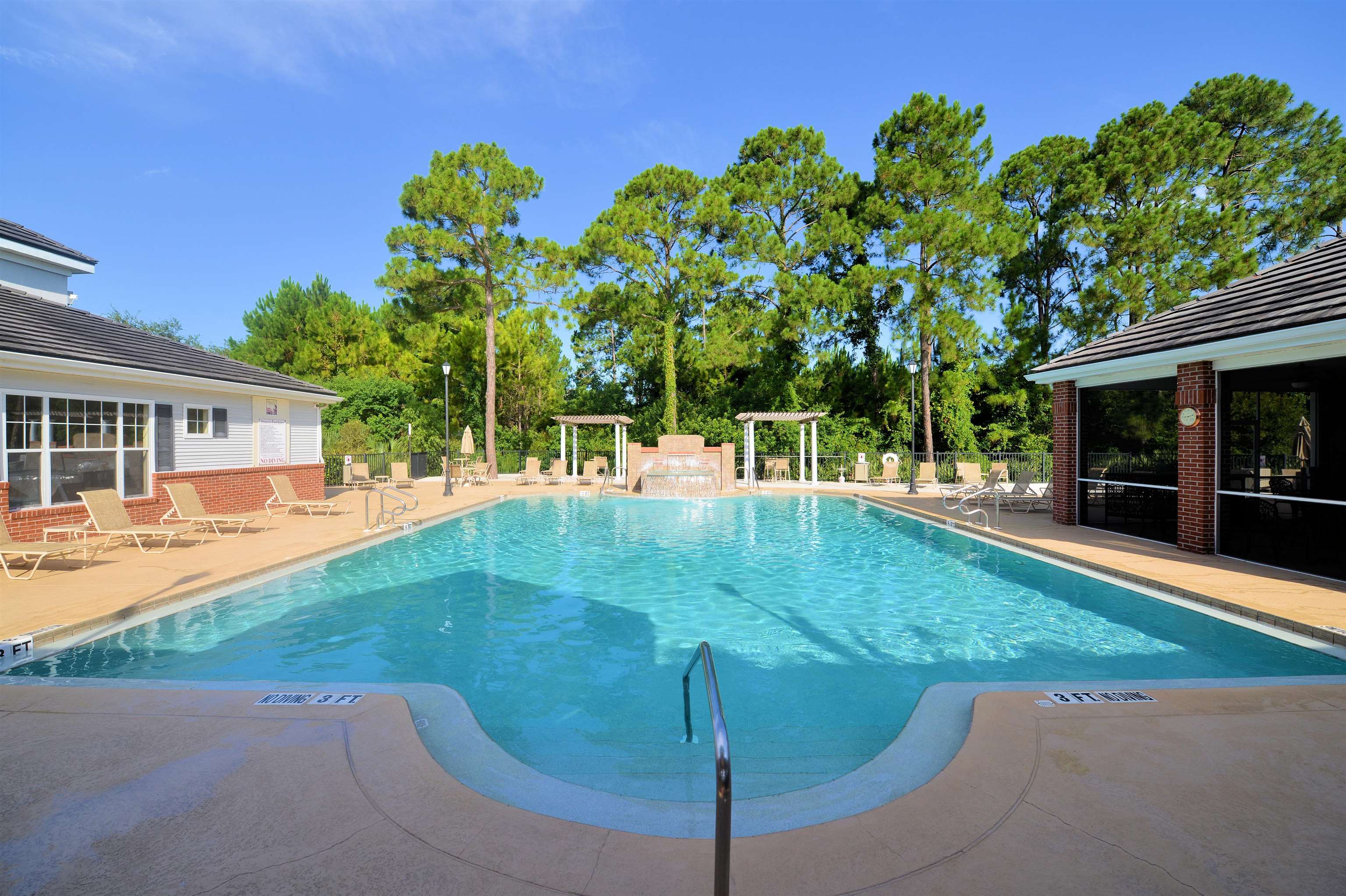 11207 Harbour Vista Circle, Unit 11207 St. Augustine, FL 32080 - Photo 33 of 42 a backyard of a house with table and chairs plants and large tree