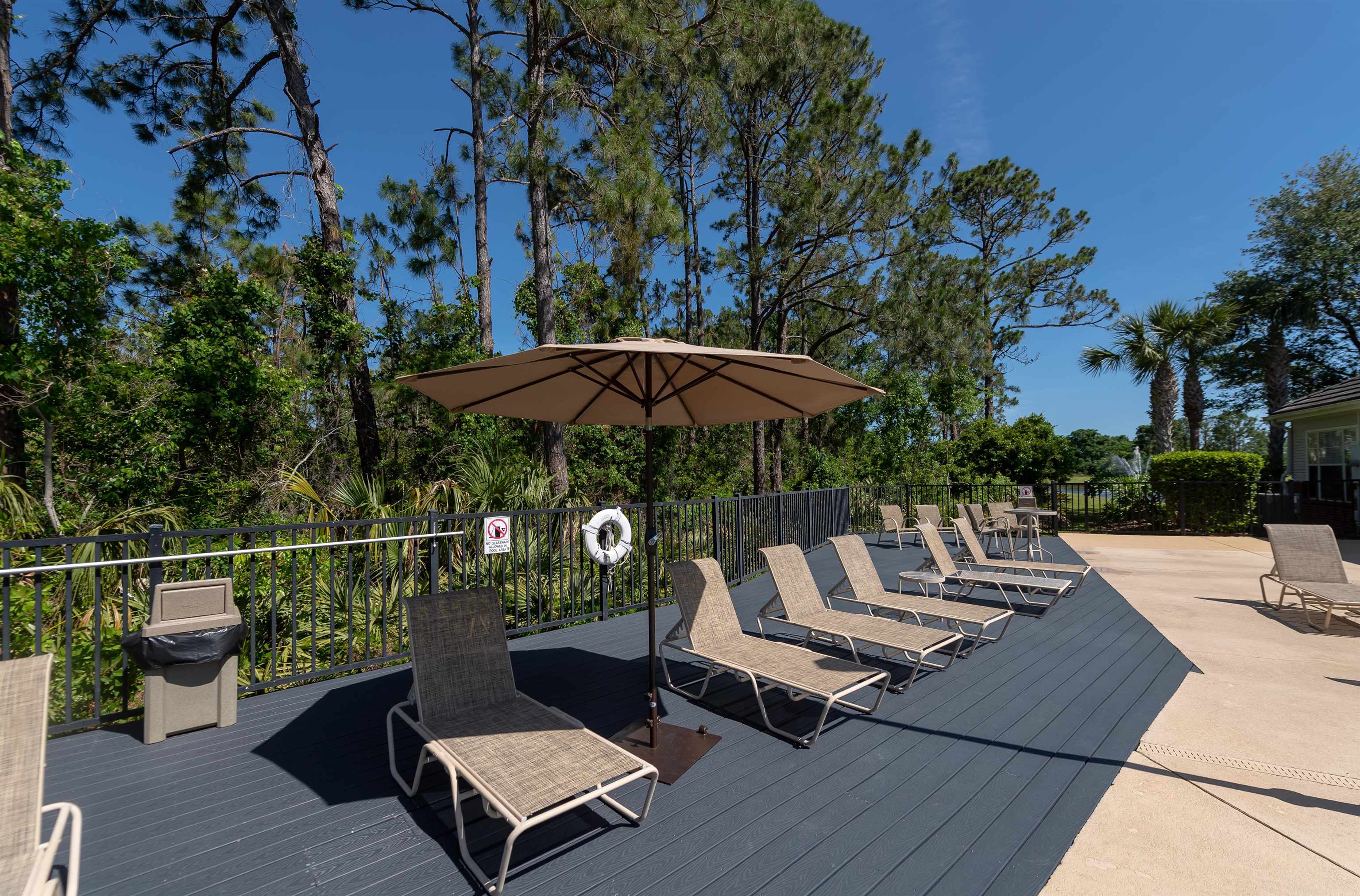 11207 Harbour Vista Circle, Unit 11207 St. Augustine, FL 32080 - Photo 34 of 42 an outdoor sitting area with furniture and wooden floor