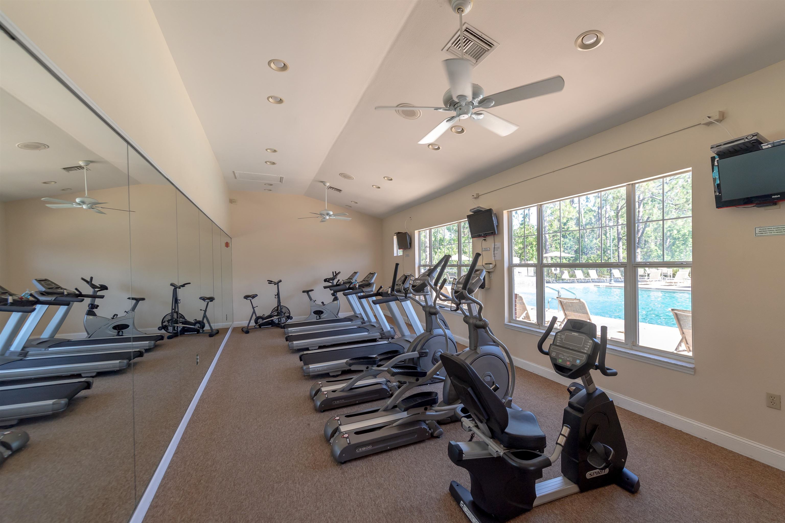11207 Harbour Vista Circle, Unit 11207 St. Augustine, FL 32080 - Photo 38 of 42 a room with gym equipment and a large window