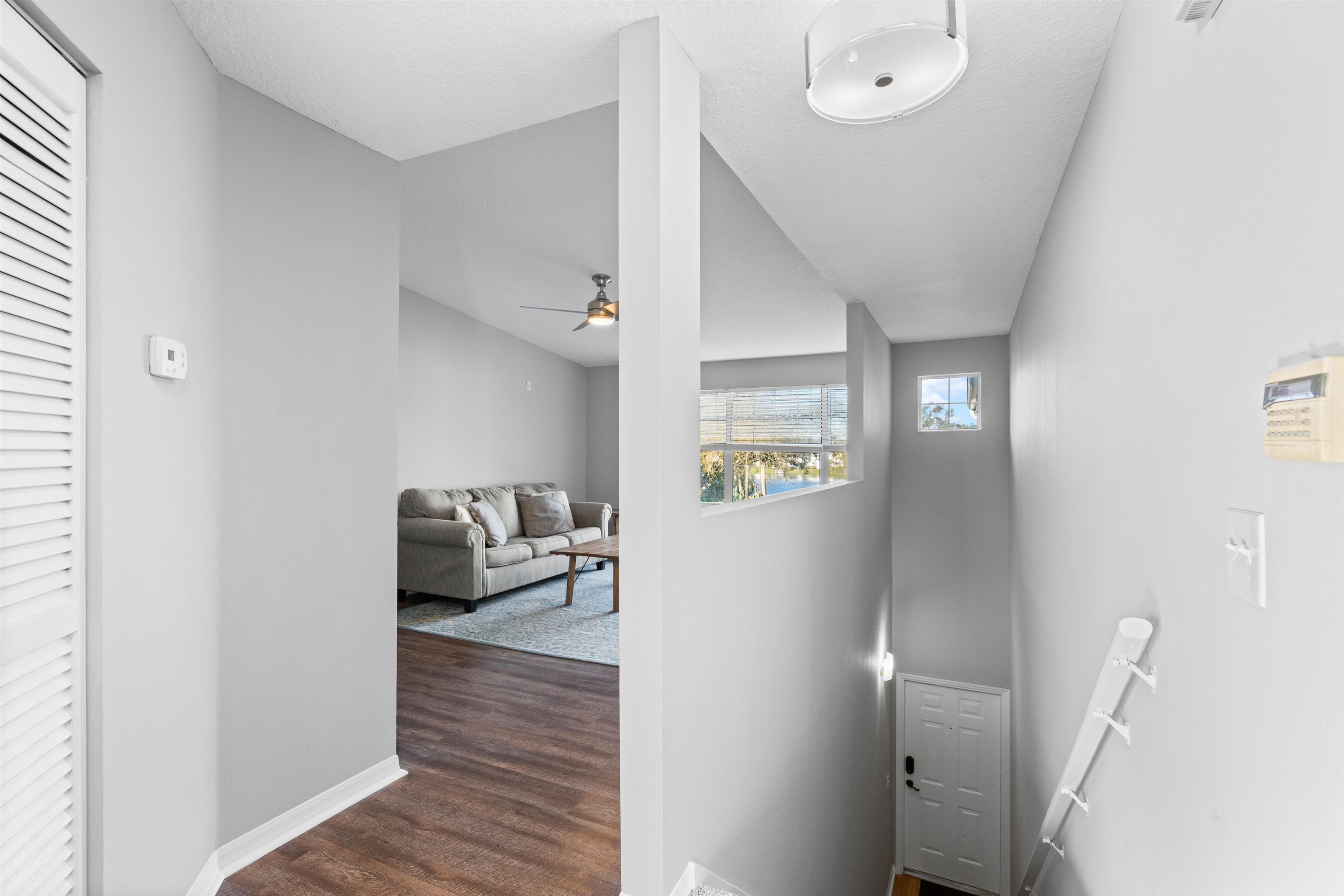 11207 Harbour Vista Circle, Unit 11207 St. Augustine, FL 32080 - Photo 4 of 42 a living room with furniture and a wooden floor