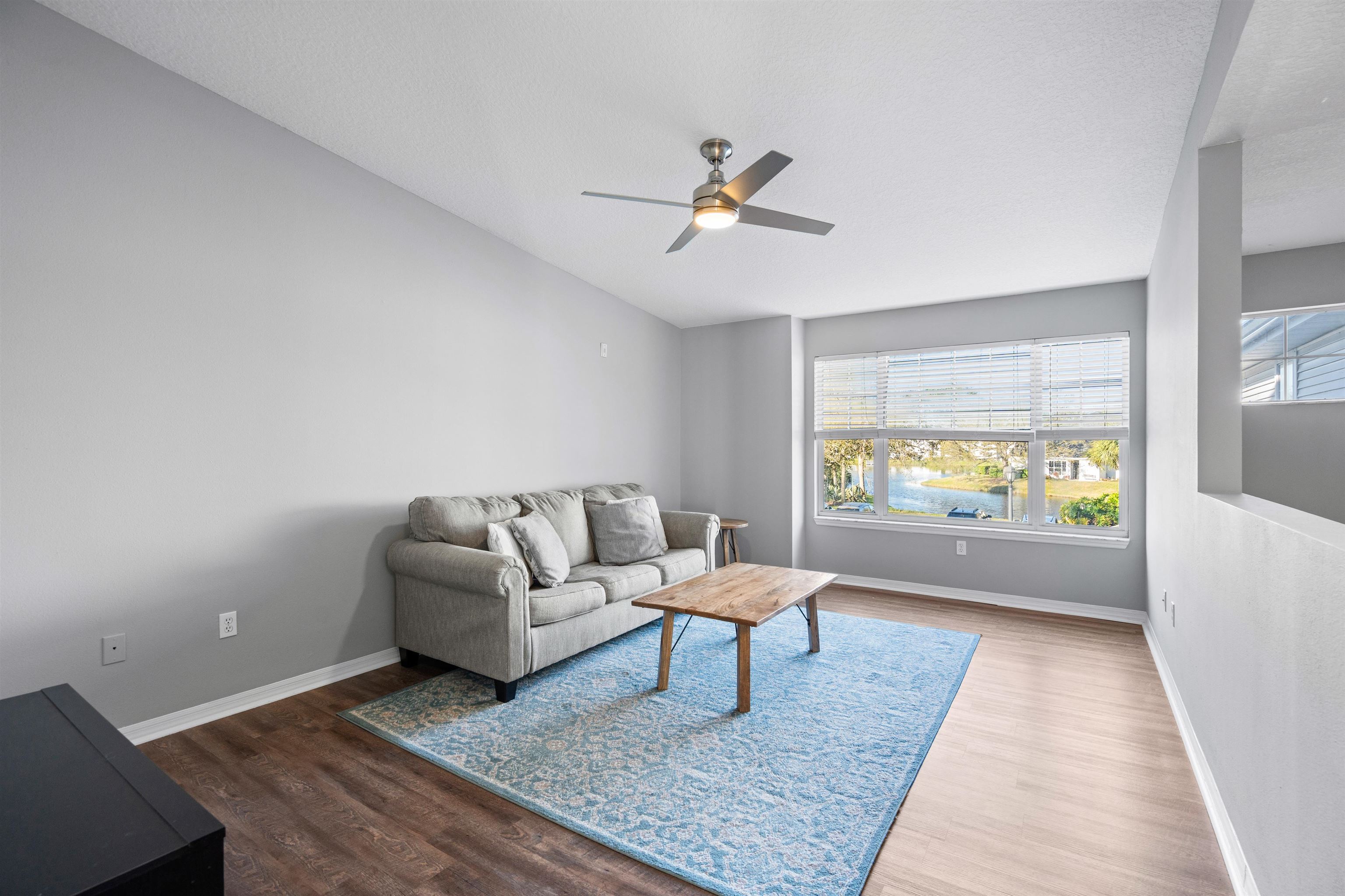 11207 Harbour Vista Circle, Unit 11207 St. Augustine, FL 32080 - Photo 5 of 42 a living room with a couch and a table