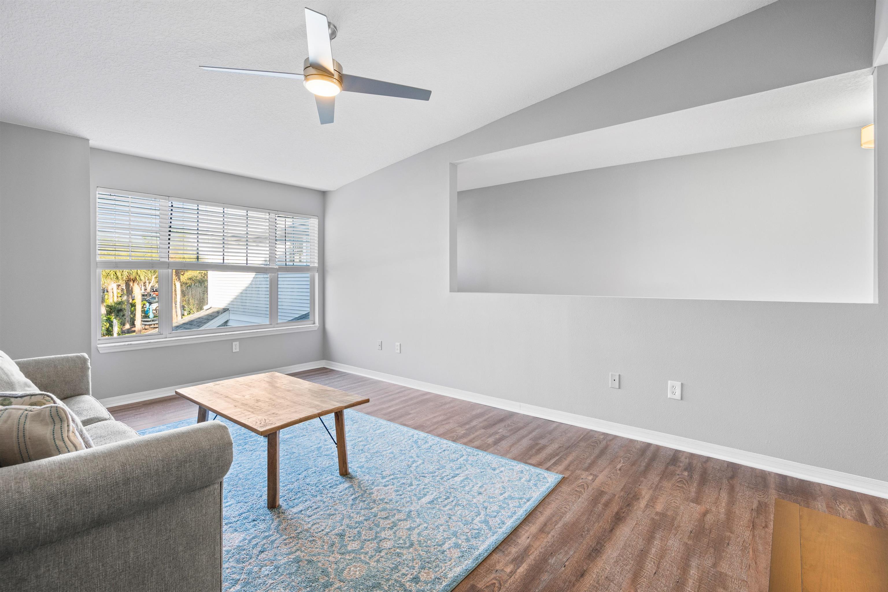 11207 Harbour Vista Circle, Unit 11207 St. Augustine, FL 32080 - Photo 6 of 42 a living room with furniture and a window