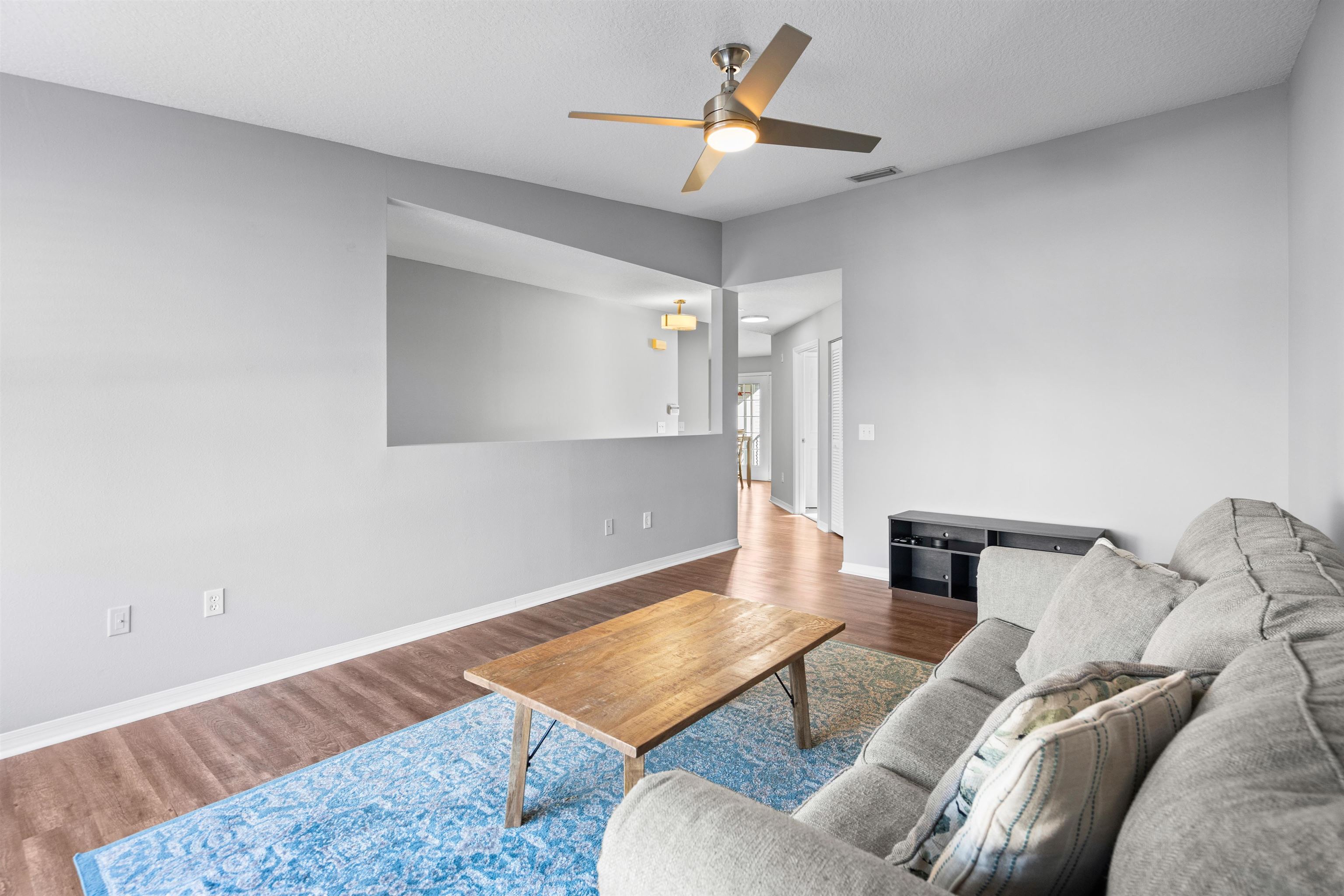 11207 Harbour Vista Circle, Unit 11207 St. Augustine, FL 32080 - Photo 7 of 42 a living room with furniture and a rug