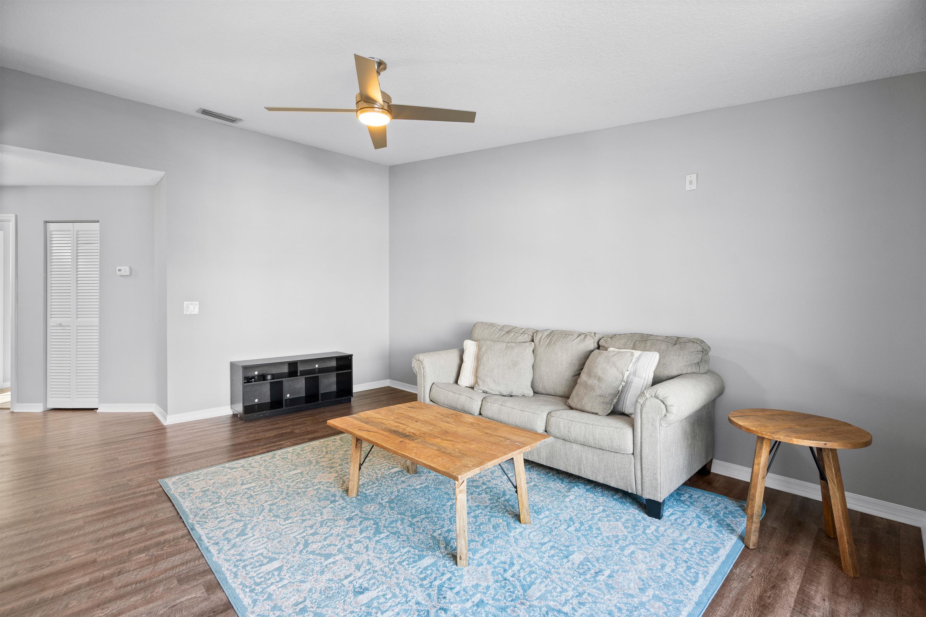 11207 Harbour Vista Circle, Unit 11207 St. Augustine, FL 32080 - Photo 8 of 42 a living room with furniture and a fireplace