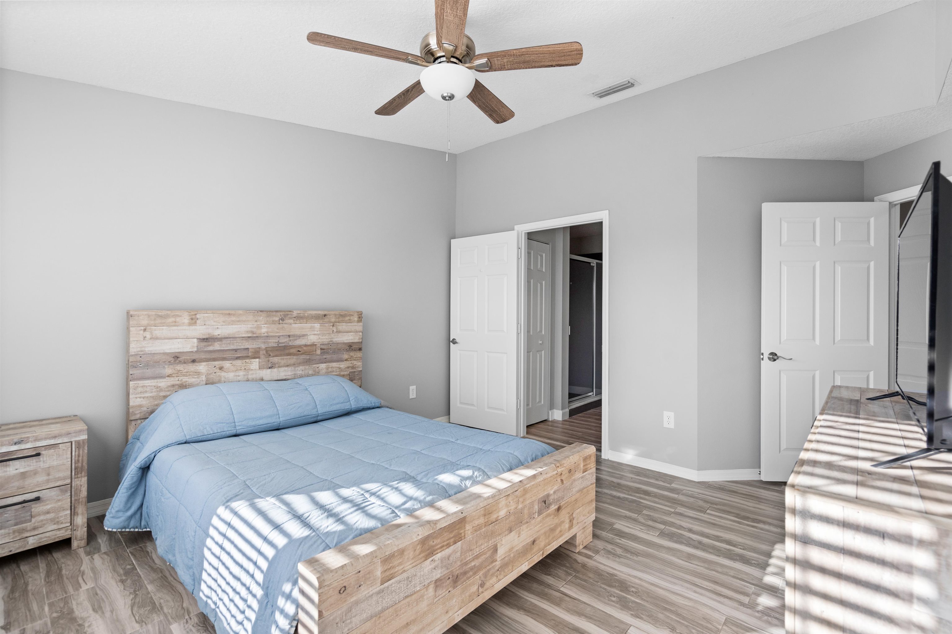 11207 Harbour Vista Circle, Unit 11207 St. Augustine, FL 32080 - Photo 10 of 42 a bedroom with a bed and wooden floor