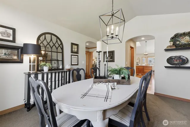 a view of a dining room and hall with furniture