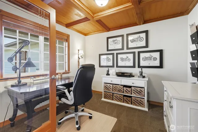 a view of a workspace with furniture and a window