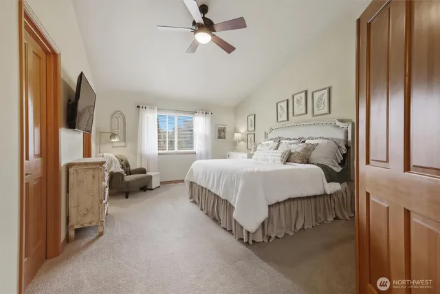 a bedroom with a bed couch and a window