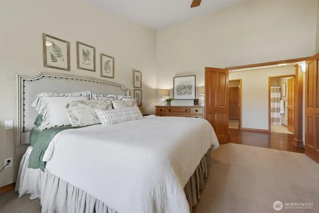 a bedroom with a large bed and a chandelier