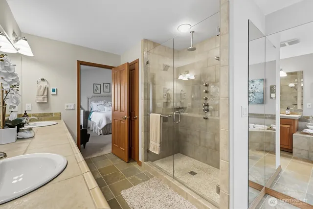 a bathroom with a shower and a sink