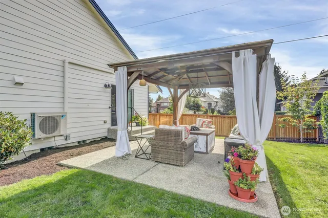 a patio with table and chairs and potted plants