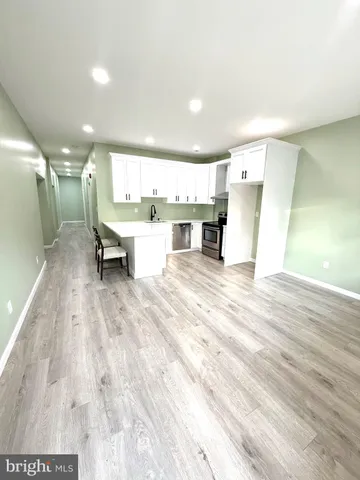 a large white kitchen with a large window