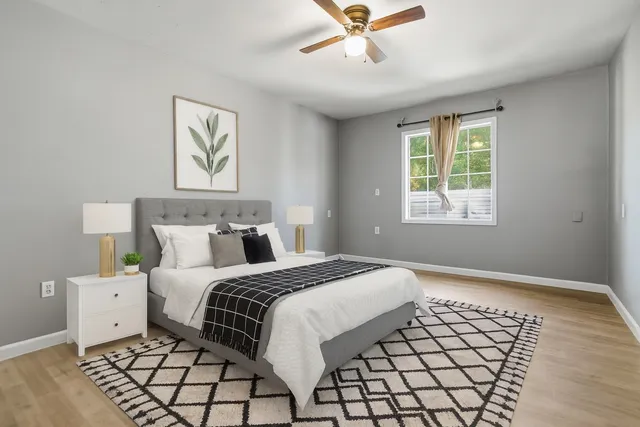 a bedroom with a bed and a window