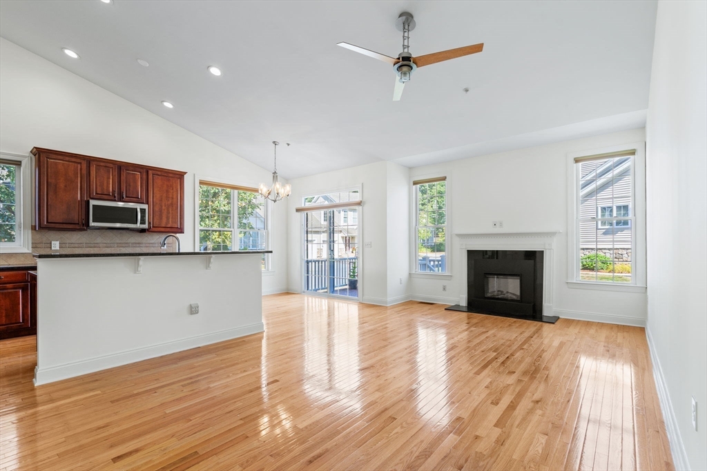 a view of empty room with wooden floor and fireplace