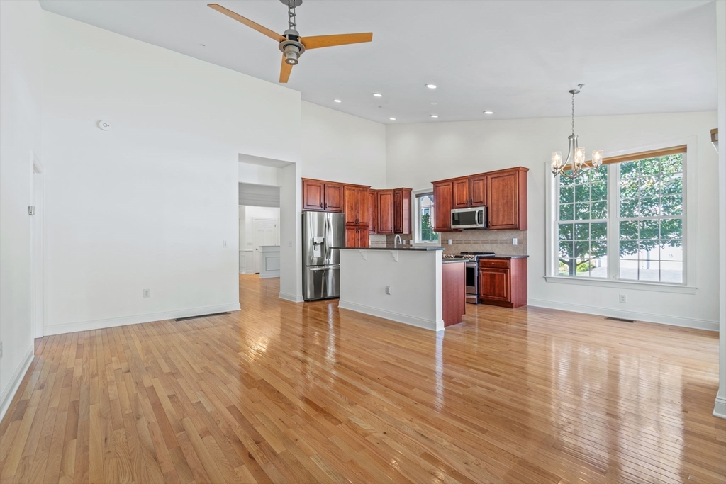 11 Pondside Lane, Unit 11 Bolton, MA 01740 - Photo 14 of 29 a view of kitchen with wooden floor and window