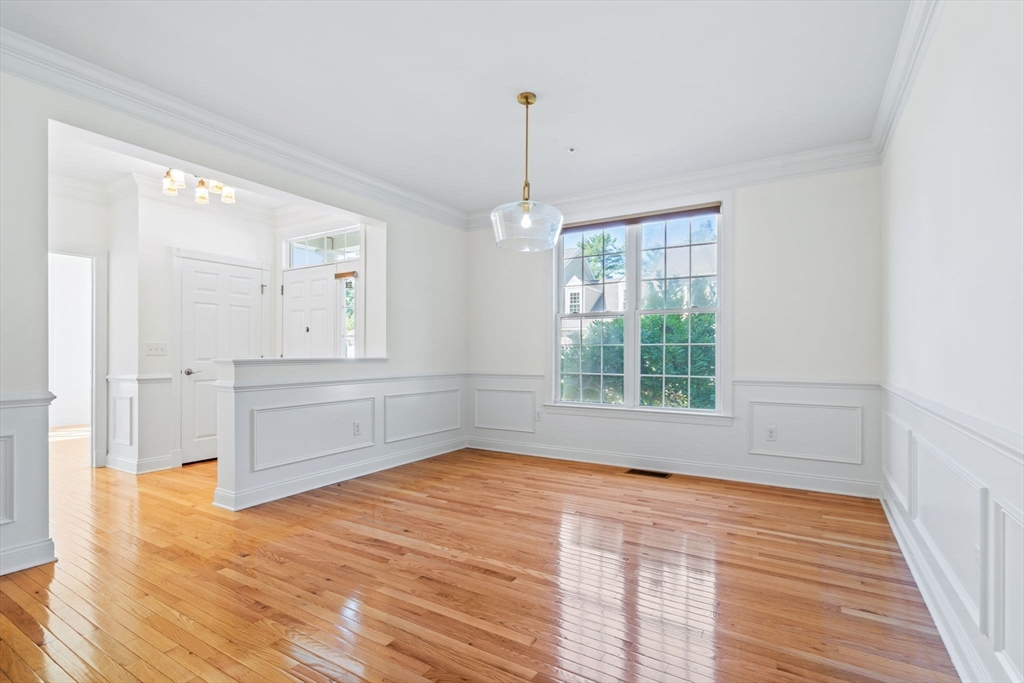 11 Pondside Lane, Unit 11 Bolton, MA 01740 - Photo 15 of 32 a view of empty room with wooden floor and fan