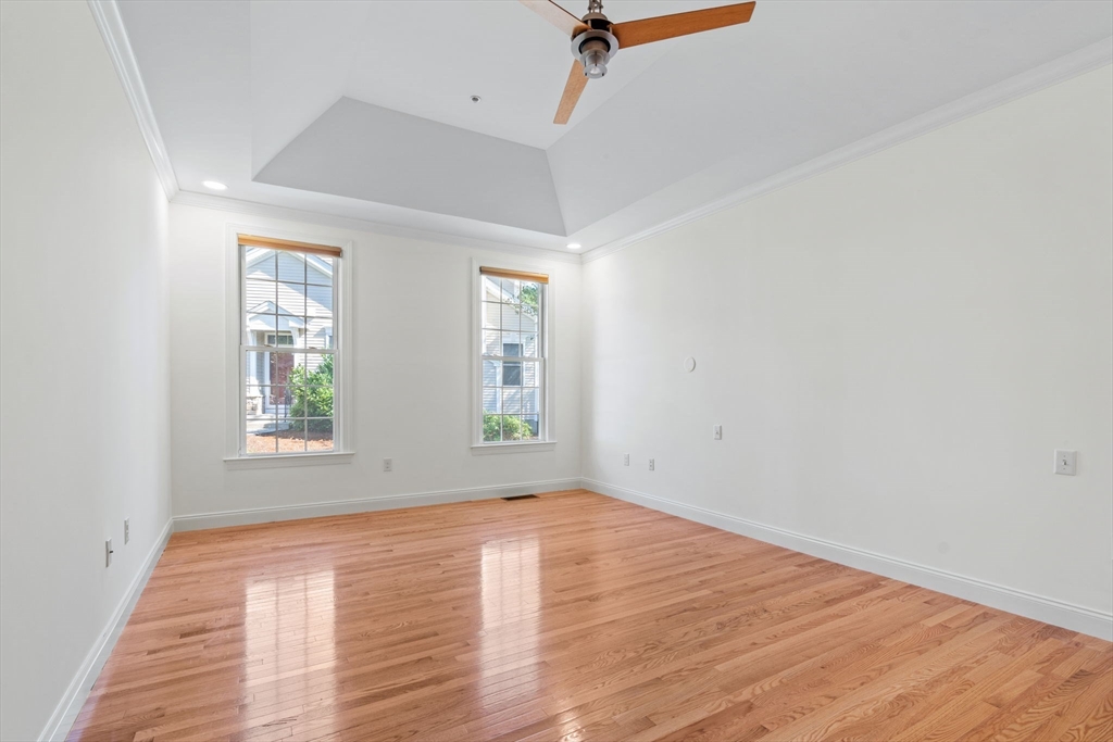 11 Pondside Lane, Unit 11 Bolton, MA 01740 - Photo 19 of 29 an empty room with wooden floor and windows