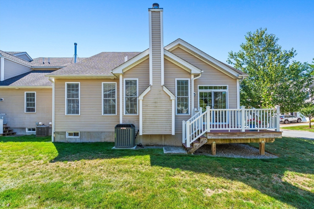 11 Pondside Lane, Unit 11 Bolton, MA 01740 - Photo 28 of 32 a front view of a house with a yard