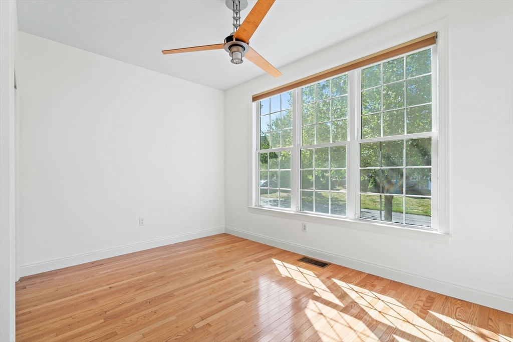 11 Pondside Lane, Unit 11 Bolton, MA 01740 - Photo 9 of 29 a view of empty room with wooden floor and fan