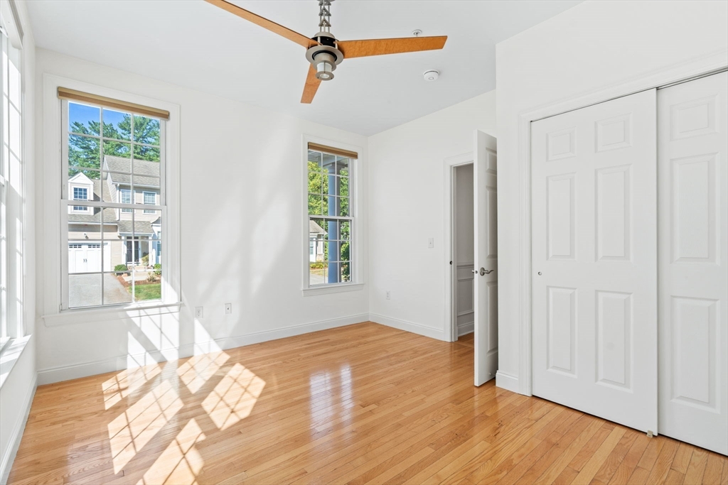 11 Pondside Lane, Unit 11 Bolton, MA 01740 - Photo 10 of 29 a view of empty room with wooden floor and fan