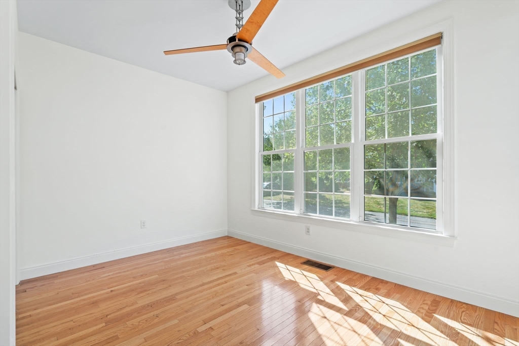 11 Pondside Lane, Unit 11 Bolton, MA 01740 - Photo 10 of 32 a view of empty room with wooden floor and fan