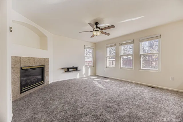 a view of empty room with a fireplace