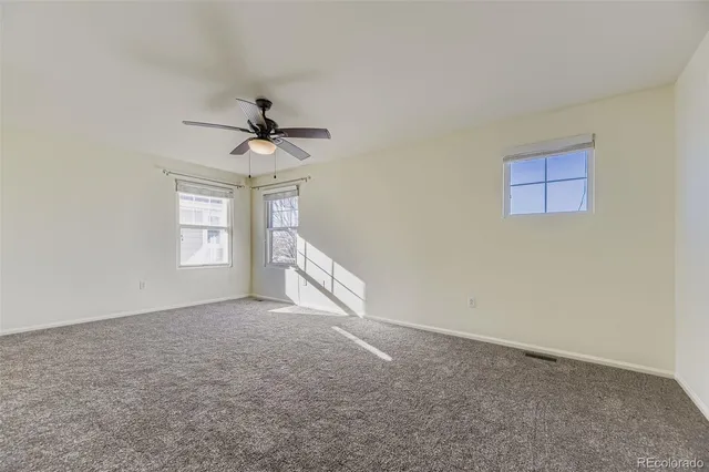 a view of a livingroom with a ceiling fan and window