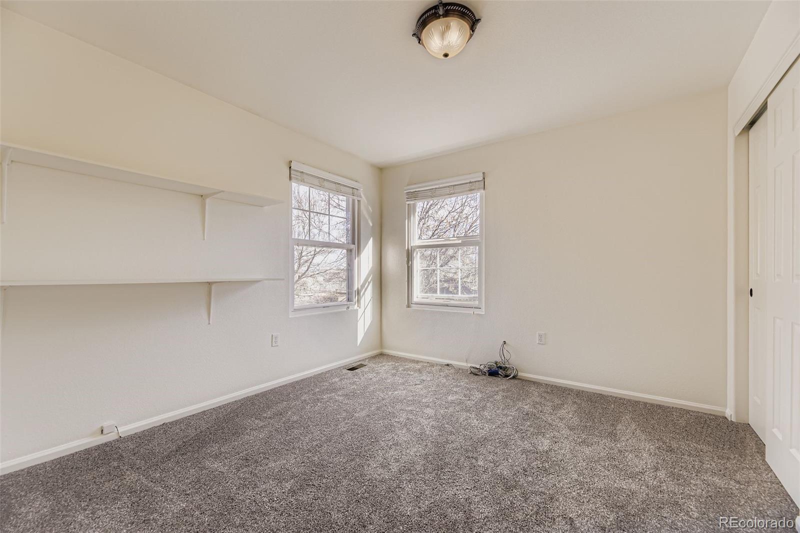 2430 South Jebel Way Aurora, CO 80013 - Photo 20 of 28 an empty room with windows