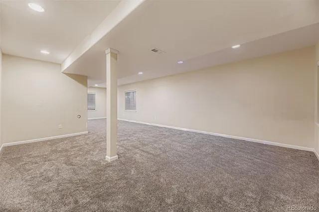 an empty room with a ceiling fan and entryway