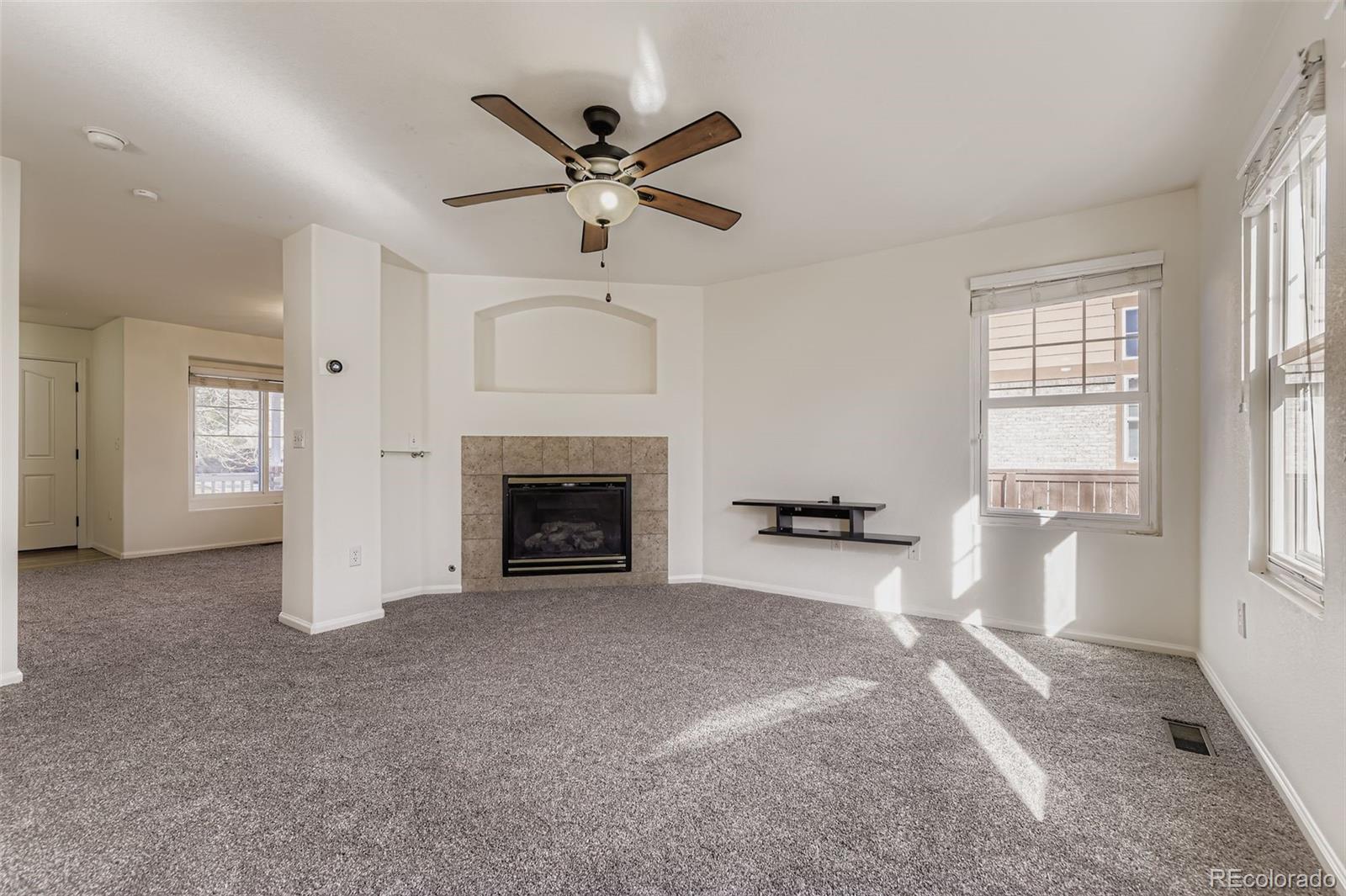 2430 South Jebel Way Aurora, CO 80013 - Photo 5 of 28 a living room with furniture and a fireplace