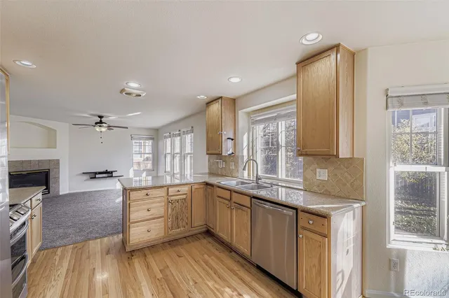 a large kitchen with a lot of counter space and wooden floor