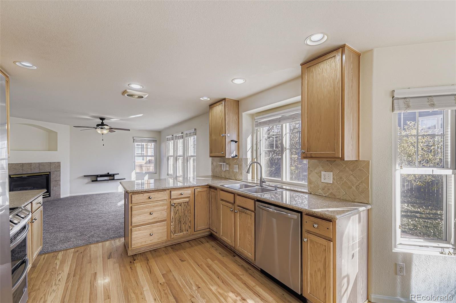 2430 South Jebel Way Aurora, CO 80013 - Photo 6 of 28 a large kitchen with a lot of counter space and wooden floor