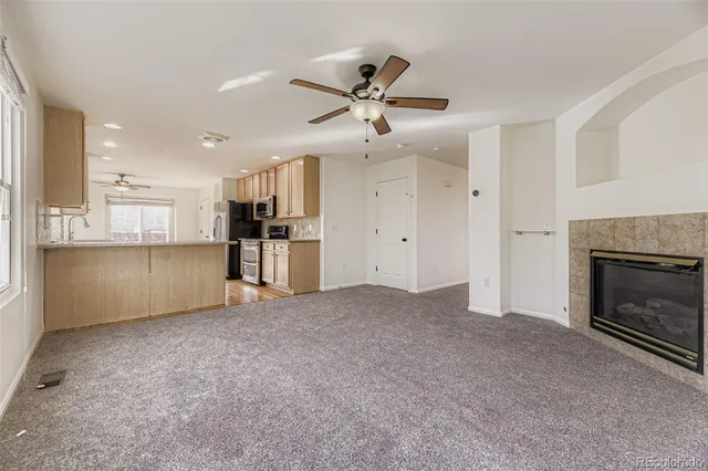 a view of a kitchen with a sink and a ceiling fan