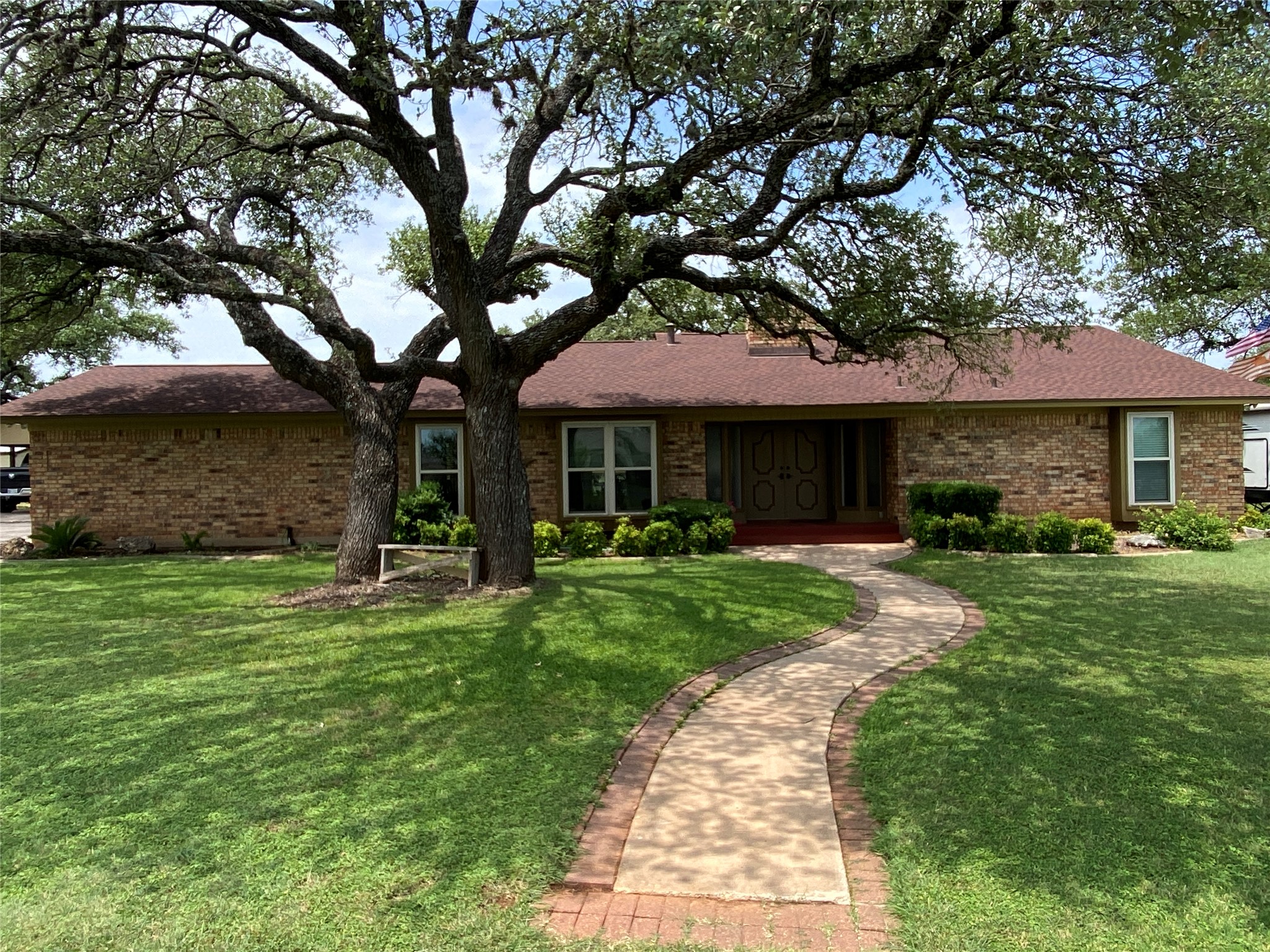 Ranch-style house with a front yard and brick siding